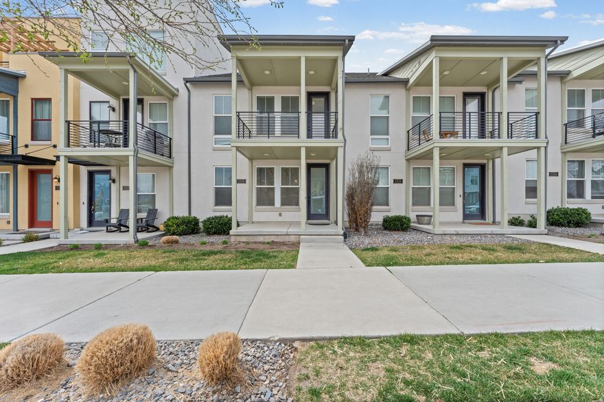 Welcome to this stunning townhome in the highly sought-after Daybreak community, offering 3 bedrooms, 2 baths, a 2-car garage, and a bright open layout designed for modern living. From the moment you walk inside, you'll notice the tall ceilings and abundant natural light that make the home feel spacious and inviting. The chef-inspired kitchen is the heart of the home, featuring a large quartz island with bar seating, beautiful backsplash, gas range, and a spacious walk-in pantry with ample shelving. The kitchen flows seamlessly into the family room, creating the perfect space for hosting gatherings or enjoying quiet evenings at home. Large windows fill the space with natural light, and a ceiling fan adds comfort year-round. Upstairs you'll find the oversized primary suite, a relaxing retreat with large windows, ceiling fan, and plenty of space to unwind. The en-suite bathroom features double sinks with quartz countertops, tile flooring, a modern three-quarter shower, and a generous walk-in closet. The upstairs laundry room offers convenience and functionality with tile flooring and plenty of room to work, and don't forget the nest thermostat. Just beyond is the mechanical room featuring a tankless water heater, ensuring endless hot water. Two additional upstairs bedrooms feature tall ceilings and great natural light. One bedroom includes charming French doors that open to a Romeo and Juliet balcony, the perfect place to enjoy a quiet morning or evening breeze. These bedrooms share a well-appointed full bathroom with tile flooring and quartz countertops. The oversized two-car garage includes additional built-in shelving for excellent storage. The location is exceptional, situated near the Salt Lake Bees ballpark with quick access to the Mountain View Corridor, WinCo Foods, and a wide variety of nearby shopping, restaurants, and everyday conveniences. Residents also enjoy full access to all the incredible Daybreak amenities including lakes, parks, trails, pools, and community events. A full list of amenities can be found at www.livedaybreak.com. Homes like this don't come along often, schedule your private showing today. Buyer and Buyers agent to verify all information. Square footage figures are provided as a courtesy estimate only. Buyer is advised to obtain an independent measurement.