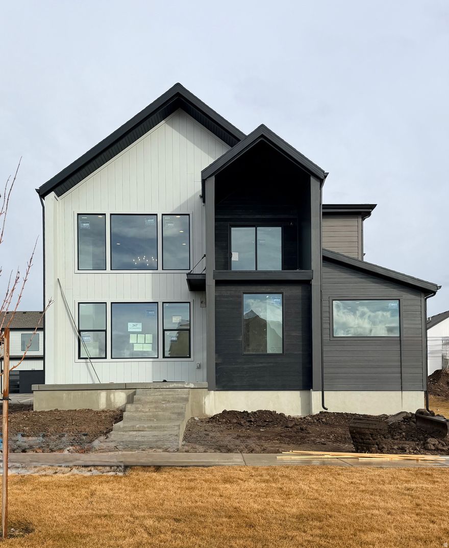 Big Price Drop!   Welcome to Lot 267 in The Crossings-Heber's premier luxury community surrounded by breathtaking mountain views. This Glacier Rear Load Floor Plan offers elevated mountain living with 6 bedrooms, 4.5 bathrooms, and a fully finished basement across 4,478 sq ft, plus over $181,000 in upscale upgrades. The home shines with a gourmet kitchen featuring double ovens and quartz countertops, beautiful luxury vinyl flooring throughout, and dramatic 20-ft vaulted ceilings that fill the space with light and openness. Enjoy finished front and back landscaping and low-maintenance living-the HOA covers yard care for all areas not enclosed by fencing. Current amenities include a park, playground, and community fire pit, with future plans for a pool and clubhouse. Ideally located near shopping, two reservoirs within 15 minutes, and just 20 minutes from Park City, The Crossings is a high-class, sought-after destination for those who want both elegance and adventure close by. Home will be complete by Mid March 2026.