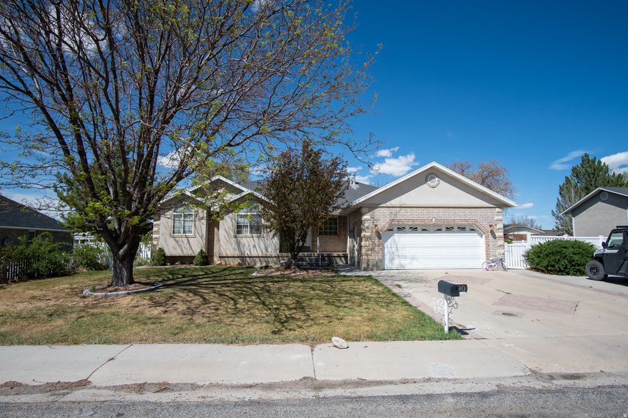 Enjoy country living in this charming rambler in Salina. A formal living room welcomes you just off the entry, leading into a spacious open-concept layout featuring a large family room with a cozy corner fireplace. The grand kitchen offers solid wood cabinets, a large central island, and a convenient closet pantry.  The primary suite includes an attached en suite bathroom with a dual-sink vanity, step-in tub, separate step-in shower, and a walk-in closet. Two additional main-level bedrooms and a full hall bathroom. A dedicated laundry room on the main level adds to the ease of single-level living. Step outside to enjoy the incredible covered back deck and a fully fenced, landscaped backyard. Additional features include a 2-car garage and RV parking.  Square footage figures are provided as a courtesy estimate only. Buyer is advised to obtain an independent measurement.