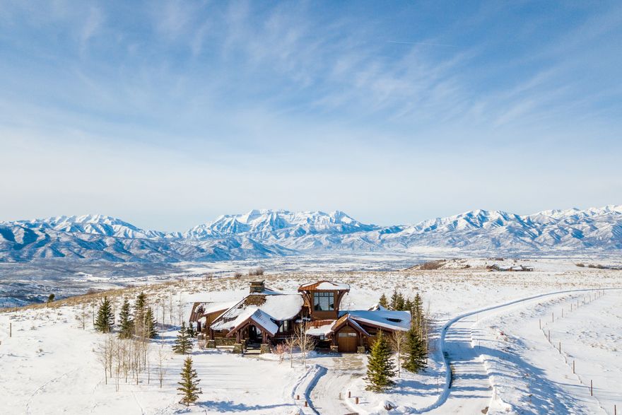 Situated in the heart of Wolf Creek Ranch, this extraordinary 6,100 sqft mountain retreat is more than just a home-it's an escape into nature's grandeur. While the property spans an impressive 160 acres, the home is thoughtfully situated on approximately 10 manageable acres, offering a balance of easy upkeep and the unparalleled privacy of an additional 150 acres of surrounding land.  Designed to elevate every moment, this rare gem seamlessly blends rustic charm with refined luxury. Soaring windows flood the space with natural light, while vaulted ceilings with exposed timber beams create a breathtaking welcome. With 3 bedrooms, 4.5 bathrooms, and a beautifully crafted barn that accommodates up to four horses or all the motorized toys you desire, this property offers the perfect balance of elegance and functionality. Whether you seek solitude, adventure, or the ideal space to gather with loved ones, this home delivers in every way.     Wolf Creek Ranch offers an unmatched lifestyle-a private, gated sanctuary with 60 miles of scenic trails for hiking, horseback riding, and winter adventures. Cast a line in private trout ponds, relax along the pristine Provo River, or unwind at the Ranch Center, complete with a community kitchen, fire pit, and owner's loft. Horse enthusiasts will appreciate the community's well-maintained equestrian facilities, offering a relaxed program with plenty of space to ride and explore the vast landscape. With a fuel center for ATVs and snowmobiles, every season brings new possibilities. Don't just dream about mountain living-experience it. Come see for yourself why Wolf Creek Ranch is where adventure meets serenity.