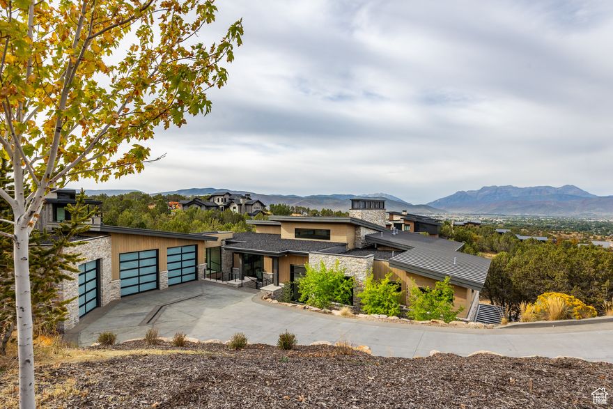 Discover the perfect blend of luxury, comfort, and privacy in this 5,851 sq. ft. mountain estate, thoughtfully designed and crafted by JD Construction. Situated on .83 acres in the prestigious Red Ledges community, this home offers seclusion among mature juniper trees while showcasing panoramic views of the Wasatch Mountains. Step inside to soaring ceilings and a striking marble-slab fireplace in the great room, where natural light frames the sweeping vistas. The gourmet kitchen is a chef's dream, featuring an oversized island, Thermador appliances, two dishwashers, and a dedicated ice maker-perfect for entertaining on any scale. With 5 spacious bedrooms, 5 full bathrooms, and 2 powder rooms, the home provides both privacy and convenience for family and guests. The oversized 3-car garage and heated driveway make mountain living effortless year-round. Unwind on expansive patios, take in the mountain air, and enjoy the unmatched amenities of Red Ledges, including golf, dining, swimming, and club facilities. A full Golf Membership is available with this property.