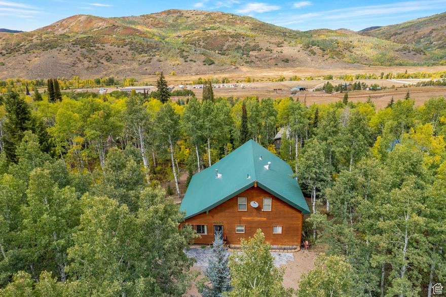 Look no further . . . this quaint & cozy cabin in the trees has everything you could desire. Located in the beautiful setting of Pine Mountains just 5 miles from the town of Oakley up the Weber River canyon. This gated cabin community features acres  of open space, new Pickleball and basketball courts, along with access to miles of trails for your favorite summer or winter recreation.  The cabin itself is perfect for quiet weekends or hosting a crowd of family and friends.  The classic log exterior has plentiful deck space and includes a closed in porch for even more useable space in any weather.  Four different heat sources keep this cabin warm and cozy in the winter months, while the cool summer breezes offer a great escape from the valley heat. The primary suite offers direct access to the exterior deck for enjoying the sounds and smells of the mountains.  The basement offers extra space for hosting guests or storing  toys, along with an extra deep garage with workshop area. Plenty of RV and guest parking in the semi-circle driveway.  Truly a million dollar cabin without the big price-tag.  Seller is motivated and  will consider all offers.