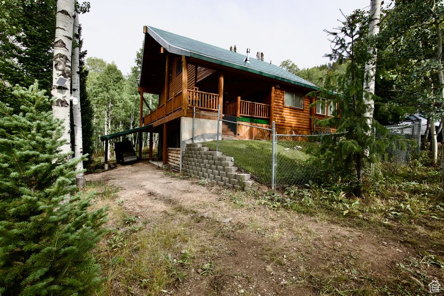 New Price just in time for Summer! Now, the BEST VALUE in Pine Mountains! No need to pay millions for a cabin when this quaint & cozy cabin in the trees has everything you need for quick getaways or long summer vacations. Access is just 5 miles from the town of Oakley up the Weber River canyon. This gated cabin community features acres of open space, new Pickleball and basketball courts, along with access to miles of trails for your favorite summer or winter recreation.  The cabin itself is well suited for quiet weekends or hosting a crowd of family and friends.  The classic log exterior has plentiful deck space and includes a closed in porch for even more useable space in any weather.  Four different heat sources keep this cabin warm and cozy in the winter months, while the cool summer breezes offer a great escape from the valley heat. The primary suite offers direct access to the exterior deck for enjoying the sounds and smells of the mountains.  The basement offers extra space for hosting guests or storing  toys, along with an extra deep garage with workshop area. Plenty of RV and guest parking in the semi-circle driveway.  Truly a million dollar cabin without the big price-tag.  Seller is motivated and will consider all offers.