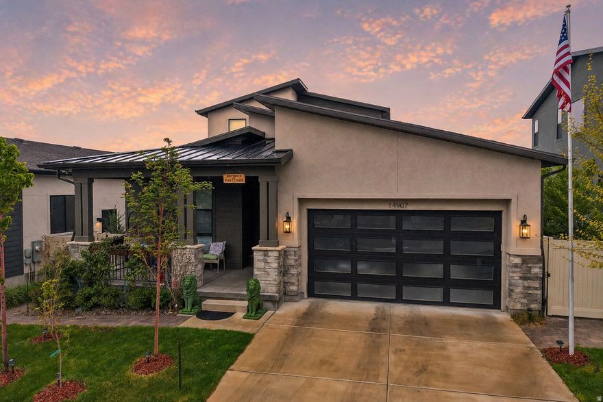 GRAND OPENING | OPEN HOUSE | MAY 2 | 11AM-2PM | Experience elevated living in the highly sought-after, gated Rosecrest community of Herriman, where nearly $500,000 in curated upgrades create a home that must be seen to be fully appreciated. The main level sets an immediate tone of luxury, anchored by a primary suite with a spa-inspired bathroom featuring heated floors and an expansive walk-in shower, plus a custom-built walk-in closet. A private guest ensuite completes the main-level living with effortless convenience. The chef's kitchen is designed to impress; upgraded appliances, a built-in espresso machine, wine fridge, and sweeping granite countertops flow seamlessly beneath soaring ceilings and rich engineered hardwood floors. Step outside to not one, but two stunning outdoor living spaces. The main-level covered patio and the yard-level terrace both frame breathtaking mountain views, while a third patio area in the yard invites year-round entertaining around a built-in gas fireplace. A pergola with ceiling fan and ambient lighting, mature fruit trees and grapevines on a drip system, and lush landscaping complete this private backyard sanctuary. The daylight basement extends the lifestyle with a full second kitchen, a dedicated workout space, and a spa-like bathroom with soaking tub and large sauna. Negotiable items that may convey include a hot tub, washer and dryer, large refrigerator, premium window coverings, garage shelving, and garden furniture, making this an exceptional opportunity to move in with virtually everything in place. Additional highlights include a 2-car garage with EV plug, tankless water heater, water softener, radon mitigation system, dual furnaces and A/C units, and abundant storage throughout. Residents enjoy exclusive access to a community pool and fitness center. Luxury, privacy, and lifestyle - all in one remarkable home.