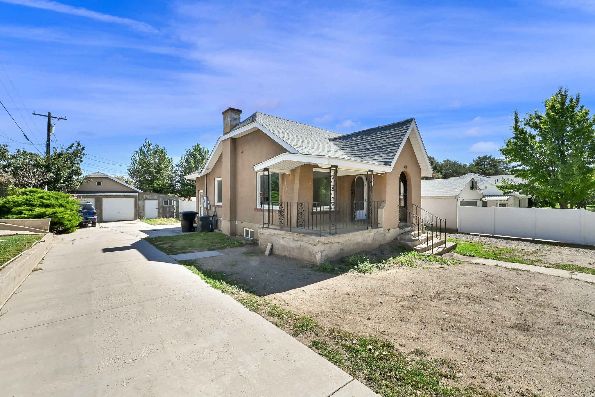 Stucco exterior, covered entry, and pitched roofline
