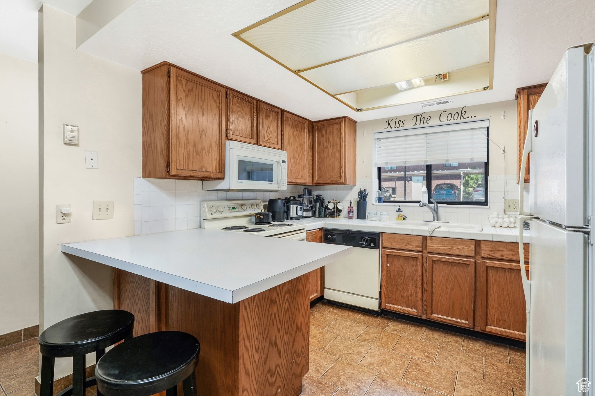 This charming and affordable 2-bedroom, 1.5-bath condo offers comfort, convenience, and a central location. Enjoy an assigned covered parking spot and easy access to downtown dining, schools, and skiing. The split-entry layout places main living spaces, kitchen, dining, and living room, on the lower level, which is partially below grade, with bedrooms upstairs. The fully finished basement includes a half bath. Ideal for buyers seeking a low-maintenance lifestyle, this home combines functionality with proximity to everything Ogden has to offer. Other units currently listed include #52 and #60, with additional units expected to hit the market soon. Buyers should contact their agent for more information. Square footage is per MLS guidelines; buyer to verify.
