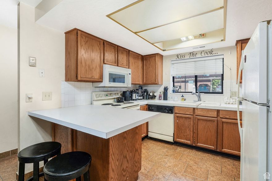 This charming and affordable 2-bedroom, 1.5-bath condo offers comfort, convenience, and a central location. Enjoy an assigned covered parking spot and easy access to downtown dining, schools, and skiing. The split-entry layout places main living spaces, kitchen, dining, and living room, on the lower level, which is partially below grade, with bedrooms upstairs. The fully finished basement includes a half bath.  Ideal for buyers seeking a low-maintenance lifestyle, this home combines functionality with proximity to everything Ogden has to offer. Other units currently listed include #52 and #60, with additional units expected to hit the market soon. Buyers should contact their agent for more information. Square footage is per MLS guidelines; buyer to verify.