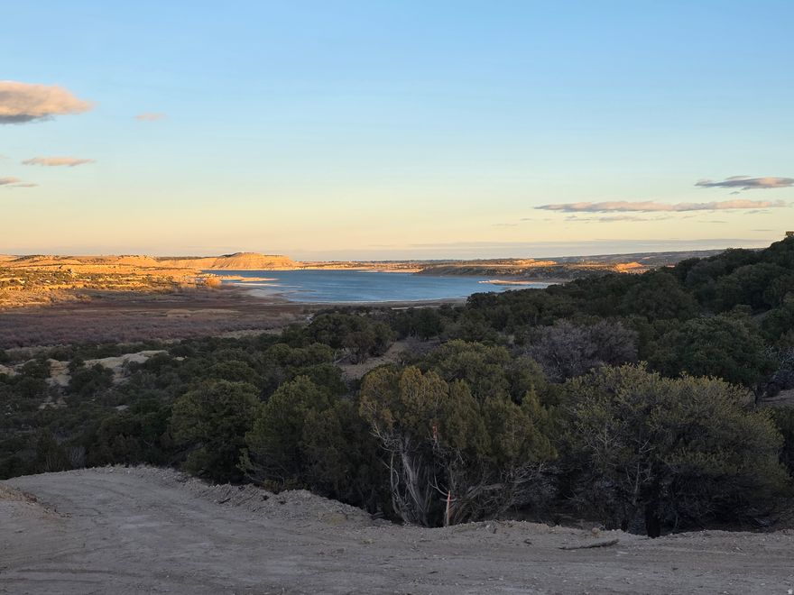 Experience panoramic Starvation Reservoir views from this 5-acre property off Koch Road - one of the most desirable areas near Duchesne. This parcel features two graded building pads, a private water well, and power already on the lot, offering immediate readiness for your home, cabin, or RV setup.  Located just minutes from Highway 40 and the Rabbit Gulch Day Use Campground, you'll enjoy paved road access most of the way and easy reach to boating, fishing, and other water recreation activities. The elevated terrain provides stunning sunrise and sunset views over the lake, while the lower pad offers privacy and flexibility for garages or guest structures.  Whether you're planning a primary residence, weekend retreat, or vacation rental, this property combines accessibility, utilities, and unmatched views, a rare find in the Starvation area. Owner financing available through Mountains West Ranches.