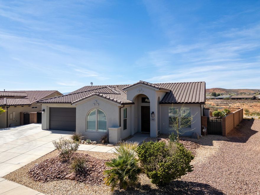 Located in the Brio community, this luxurious home rests on a large lot perfectly positioned for privacy and endless views. Experience stunning canyon and mountain vistas inside and out, with an expanded patio yard and no rear neighbors to create a truly peaceful retreat. Inside, the contemporary open concept is designed to bring those incredible views right into your daily life. A tall, double tray ceiling makes the living room feel bright and airy, flowing seamlessly into the kitchen and generous dining space. The kitchen features a large center island, granite countertops, and convenient glide-out cabinet drawers, complemented by a suite of stainless steel appliances. Double doors open right onto the patio, where a large pergola and outdoor lighting create an ideal shaded spot to enjoy the landscape. The outdoor space continues with double side yards, a storage shed, and gated RV parking  in addition to the two-car garage. You will also benefit from practical everyday upgrades, including rooftop solar panels, a water softener, and an energy saving attic blanket for maximum efficiency. In the primary bedroom, large windows frame the priceless views, and the en suite primary bathroom features a granite double vanity and walk-in shower. Two additional bedrooms provide comfortable space for guests or a home office, complete with wood shutters to filter the perfect amount of natural light. A second full bathroom and a dedicated laundry room complete the interior. Life in the Brio community feels like a year-round vacation. You have full access to the Escape clubhouse, two pools, a spa, a fitness center, eight pickleball courts, and two tennis courts. With quick access to the interstate, local parks, and golf courses, this home is the perfect base for enjoying the natural beauty and active lifestyle of the greater St. George area.