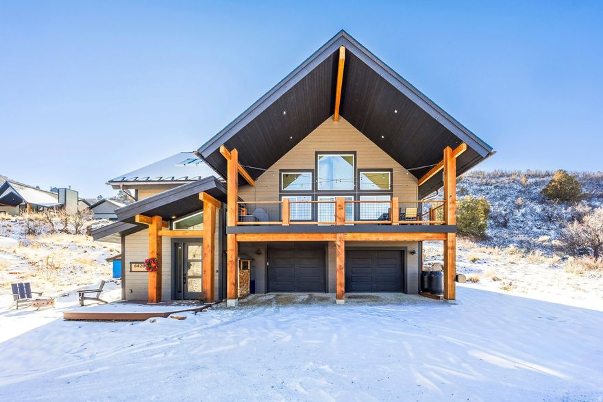 Thoughtfully designed to captivate the surrounding alpine beauty, this modern-mountain home combines contemporary style with natural elements for sustainable living. Equipped with solar panels, copper gutters, smart thermostats and ample backup systems, the home invites indoor-outdoor enjoyment at every turn. The two-story great room features vaulted ceilings, large windows, sky-lit loft and large Trex balcony for taking in the sunsets. The sun-drenched kitchen with soft-close cabinetry, new pantry, butcher-block counters and metal accents, is ideal for preparing chef-grade fare while sharing stories with family and friends. The adjacent dining area overlooks backyard gardens with occasional roaming wildlife. The main-level ensuite with tranquil deck presents an idyllic setting for stargazing. An elegant flagstone patio leads to the light-filled mudroom with heated flooring, just steps from the impressive heated three-car garage with epoxy flooring and plenty of space for ATVs, snowmobiles and outdoor gear. Enjoy endless recreation within steps of home, including three lakes and miles of trails for hiking, biking, snowmobiling and ATV's. Nestled behind the gates of Timberlakes and minutes from world-class skiing, shopping, schools and services in Heber and Park City, this rare year-round haven presents an invaluable opportunity to live amid nature without sacrificing convenience.