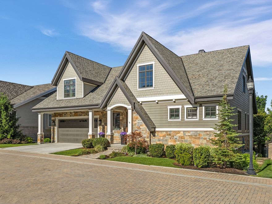 Situated on a charming brick-paver lane, this meticulously designed residence features exceptional finishes. Elegance upon entering, you are welcomed by a tall, light-filled foyer that opens to a stunning main level. The vaulted great room features custom built-in cabinetry and elegant double French doors, creating a warm yet refined gathering space. The gourmet kitchen is designed for both everyday living and entertaining, complete with coffered ceilings, Mountain Crest cabinetry, a butler's pantry, and high-end appliances.  The main level also includes a bright sunroom, a quaint office, and an exquisite owner's suite featuring a custom curbless shower, a spacious walk-in closet, and additional insulation for enhanced comfort.  Upstairs, you'll find a private en suite bedroom, a cozy sitting nook, and a spacious second office. Large family room great for entertaining. Recent improvements include custom wainscoting and updated lighting, adding an extra layer of charm and character.  The lower level is thoughtfully designed for both relaxation and entertainment, featuring a large family room with a wet bar, a dedicated workout room, and two additional bedrooms and bathrooms.  Throughout the home, premium finishes include French oak flooring, luxurious New Zealand wool carpet, custom woodwork, and beautiful wood windows and doors.  The exterior has been recently transformed with professional landscaping in both the front and back yards. Outdoor living shines with a new paver patio and walkway, Elite Gold artificial turf. The backyard also features a custom brick outdoor cooking area, perfect for entertaining, along with an included Bullfrog hot tub with a new electrical panel.  Additional amenities include a central vacuum system, split tilt-rod shutters, and a reverse osmosis system providing both hot and cold filtered water.  Conveniently located just minutes from shopping, dining, and canyon resorts, this home offers a rare opportunity to enjoy comfort, elegance, and a picture-perfect lifestyle!