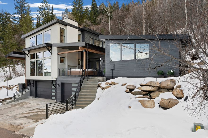 Light-filled 2024 mountain modern with elevated views, radiant heat, heated driveway, 3-car garage, and detached ADU. Built with Omni Block masonry for durability and fire resistance. Designed for easy living-minutes to trails, skiing and 30 min to SLC Airport.