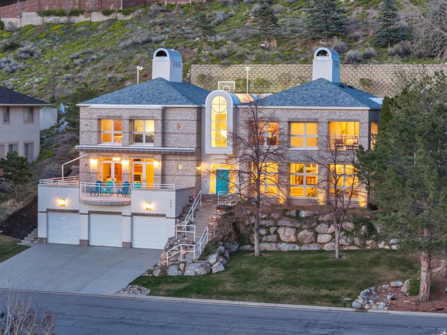 Set high on Salt Lake City's east bench, this custom built original owner home offers spectacular, unobstructed views stretching from the sparkling lights of downtown Salt Lake City across the valley to the peaks of the Oquirrh Mountains. This impressive 5-bedroom, 5-bathroom residence spans over 5,300 sq ft and occupies one of the largest lots (.32 acres) in the neighborhood. Extensively updated (20222024), the home's interior blends timeless craftsmanship with modern amenities. Rich red oak finishes, refinished hardwood floors, heated marble and porcelain flooring, and custom wood-clad windows create an elegant yet welcoming atmosphere. The grand, multi-level entryway immediately impresses with heated marble flooring, sophisticated brass railings, and an exquisite chandelier illuminated softly by a graceful skylight. The thoughtfully designed kitchen is equipped with premium Thermador and Subzero appliances, Corian countertops, custom cabinetry, and a bright breakfast nook seamlessly integrated into the home's living spaces. All five bedrooms are conveniently located on the second level, highlighted by the spacious primary suite, complete with a cozy fireplace, luxurious spa-inspired bath, and private covered balcony offering stunning views of the city skyline and surrounding mountains. Additional bedrooms include thoughtful built-ins, such as a Murphy bed, ample storage, and flexible living space. Flowing seamlessly from the kitchen is the expansive great room, accented by exposed oak beams, features a wet bar and dual French doors opening onto an oversized patio with automatic awning-perfect for entertaining, relaxing, and soaking in the unmatched views of downtown and the entire Salt Lake Valley. The professionally landscaped, tiered backyard further enhances this unique vantage point, offering multiple seating areas, an in-ground spa, half basketball court, and ground-level trampoline, all framed by one of the city's most spectacular panoramas. Additional comforts include radiant heated floors throughout, a finished walk-out basement with extensive storage, and a heated 5-car garage with dedicated workspace. Other unique amenities including a central vacuum, a charming fire pole convertible to an elevator. Ideally situated just minutes from downtown Salt Lake City, the University of Utah, and top-rated schools, this home also offers effortless access to Utah's legendary outdoor recreation. World-famous ski resorts like Alta, Snowbird, Brighton, and Park City are within easy reach, delivering Utah's acclaimed "Greatest Snow on Earth." With Salt Lake City selected to host the Winter Olympics again, this residence places you at the doorstep of Utah's renowned mountain lifestyle and exciting future events. 3D Tour Link-https://my.matterport.com/show/?m=fmwECXRVjkv&