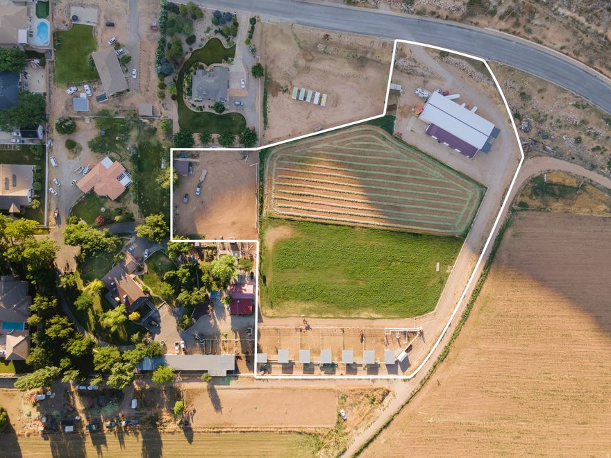 Experience the epitome of a country lifestyle. Located down historic Sycamore Lane and surrounded by the church farm, this 5.43-acre parcel offers irrigated pasture currently supporting oats and corn, or the flexibility to function as a turnout pasture with space for seven 40' x 70' covered boarding stalls. Equestrian enthusiasts will appreciate the lighted riding arena, ideal for training or evening use. A 6,000 sq ft metal warehouse with concrete flooring and a new roof provides exceptional utility, along with a 100' x 20' lean-to featuring roll-up doors. A unique opportunity for agricultural use, livestock, or storage in one of the area's most sought-after rural settings.