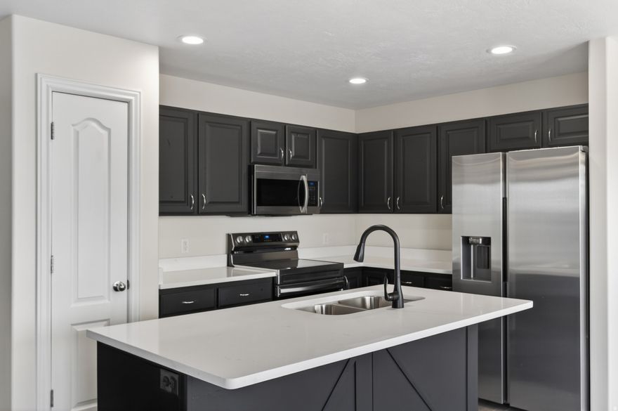 Townhome in a prime central Salt Lake Valley location near Jordan Landing, offering easy access to shopping, dining, and entertainment. The finished basement functions as a fourth bedroom and is plumbed for a fourth bathroom, with ample storage space. The home features updated interior finishes including flooring, countertops, and light fixtures, plus a freshly painted garage. HOA amenities include a playground and a fully fenced dog park.