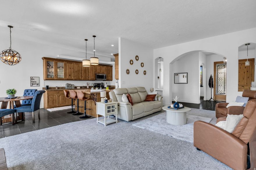 Beautifully updated Lehi home featuring soaring 12-foot ceilings, abundant natural light, and stunning unobstructed views in one of Utah County's most desirable and rapidly growing areas. Major upgrades include a brand-new roof with a 50-year lifespan, new furnace and A/C unit, new water heater, new carpet, upgraded flooring, fresh paint throughout, and top-of-the-line appliances-offering true move-in-ready peace of mind. The spacious kitchen includes an expansive walk-in pantry, while the versatile walk-out basement offers incredible potential for a mother-in-law apartment, rental income opportunity, home gym, theater, or additional living space. Conveniently located near Silicon Slopes, Thanksgiving Point, Traverse Mountain shopping and dining, parks, trails, top-rated schools, and quick I-15 access. Homes like this in Lehi don't come around often and are expected to sell quickly. Buyer to verify all information, including square footage and acreage.