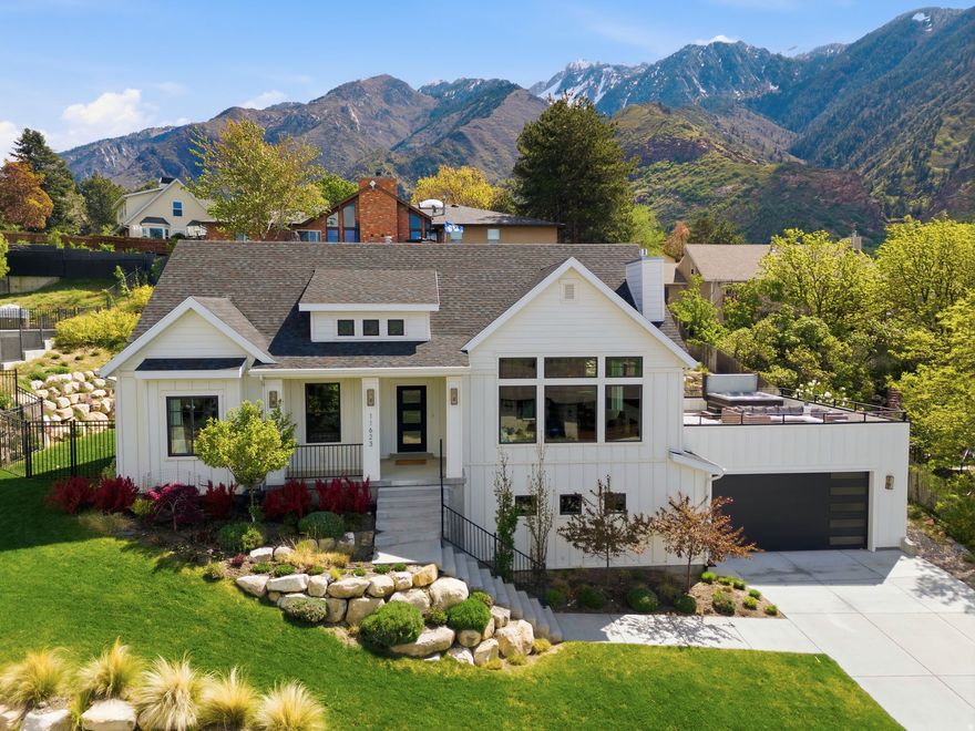 Nestled at the base of Little Cottonwood Canyon in Sandy's desirable Hidden Valley neighborhood, this custom home offers panoramic views of the valley and mountains. Inside, timeless finishes create an elegant yet comfortable space: vaulted ceilings, oversized windows that flood the home with natural light, hardwood floors, stainless steel appliances, quartz countertops, and a thoughtfully designed open-concept layout. The main living area is ideal for entertaining, with seamless access to a spacious deck and yard. From the newly built deck, enjoy sunrise over the mountains and sunsets over the valley with twinkling city lights. The bright primary suite provides a peaceful retreat with ample room to relax. Don't miss the hidden bonus: pull down the hallway stairs to discover a fully finished attic space. An additional bedroom, bathroom, office and laundry room round out the main level. Downstairs, the basement features a large family room, two bedrooms, and two full bathrooms. A flexible bonus room easily converts to a home gym, while the climate-controlled workshop and dedicated sound studio offer creative possibilities. The garage includes an EV charger, with pre-run lines ready for a heated driveway. Hidden Valley delivers year-round access to world-class skiing and hiking trails. This is a home best experienced in person. Buyers are encouraged to verify all information.