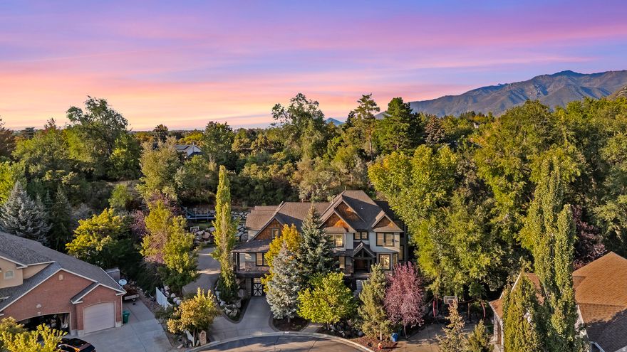 Welcome to this luxury estate located in a sought-after East Layton community. Offering 5,301 sq ft of refined living space, this exceptional home features 6 bedrooms, 4 bathrooms, an office with an entrance and a spacious 5-car garage-all set on beautifully landscaped, manicured grounds.   As you approach the home, you are greeted by a beautiful seasonal stream that sets a serene and inviting tone for the property. Designed for both elevated living and unforgettable entertaining, the outdoor spaces feature a hot tub for relaxation and elegant evening lighting that creates a warm, welcoming ambiance. Inside, you'll find expansive living areas, quality finishes, and a thoughtful layout that seamlessly blends comfort with sophistication. The lower level offers soaring coffer and tray ceilings in the basement.  Adding incredible value and flexibility to the estate is approximately 860 sq. ft. Accessory Dwelling Unit (ADU) located above the garage. Accessed via a private exterior staircase, this self-contained living space boasts a full kitchen, laundry, living room, one bedroom, and a bathroom-perfect for guests, extended family, or rental income.   The roof replaced just 5 years ago adds peace of mind and long-term value. This home is ideally located with access to world-class mountain biking and hiking trails (Adams Canyon), and a short drive to  golf courses, upscale shopping in Station Park, dining, and renowned ski resorts, including Snowbasin within a 30 minute drive! Don't miss this rare opportunity to own in one of East Layton's most desirable areas!    All information provided here and is deemed reliable, but not guaranteed. Buyers are encouraged to verify all details to their satisfaction, including but not limited to the property information, taxes, and square footage. Seller and Seller's agent disclaims any responsibility for discrepancies or inaccuracies.