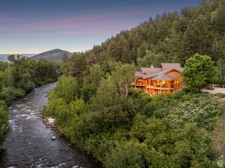 Prime River Front Property On 27 Acres At The River House.     This very rare, riverside trophy home is only 30 min from Park City & 50 min from SLC! With nearly 600 ft of Weber River frontage, extraordinary mountain & river views and ever- present, soothing river sounds, it's a truly unique oasis. The home is on a secluded lane ending at BLM land, with 27+ acres in a wondrous, natural setting. Perched 30 feet above the river and floodplain, you'll enjoy amazing views along & down river. A stairs and path from the yard leads to a river's edge patio for fishing, kayaking or just relaxing with a drink & a book. Comprised of 5 separate parcels, there's potential for development of additional mountainside or mountaintop homes with sweeping views, up & down canyon. The home is meticulously built, with 2 x 6 framed & insulated construction, a split log veneer & features an 1100 square foot, wrap-around, covered deck, with an infrared grill and an outdoor gas fireplace, a perfect spot for your morning coffee or late night stargazing. The ground level, main floor showcases Great & dining rooms, a grand, lodge-style fireplace with a stunning Vermont Castings gas stove; and two bedrooms - the primary suite, boasts direct views of the river & mountains. Both main floor bedrooms have en-suite baths and open to the wrap around deck. Upstairs you'll find a spacious loft area, a full bath & an oversized bunk room. Downstairs is a large Great room featuring a surround sound theater area with gas insert, a second kitchen & pool table, along with three spacious bedrooms, cold storage & walkout access to the yard. The home has year-round access, custom cabinetry, an under-roof hot tub (no snow shoveling to enjoy the tub!), audio inside & out, fiber internet, three propane stoves, a dog wash, an outdoor fire pit, a large, detached garage for all your toys and is offered beautifully furnished & turn-key. This is a once-in-a-lifetime opportunity to own a secluded wilderness retreat on the Weber River, only 30 minutes from the Park City slopes! Unscheduled visitors are not permitted.  Do not disturb the homeowners.