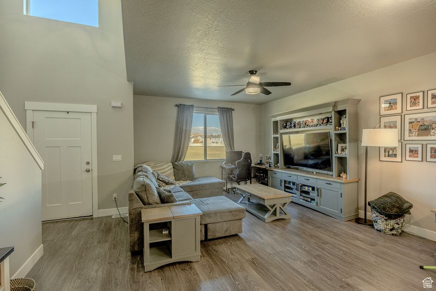 This stunning townhome in Eagle Mountain combines comfort, style, and convenience. Enjoy breathtaking mountain views with nearby parks, schools, shopping, dining, and endless outdoor activities just minutes away.  Inside, you'll find 9' ceilings and an open-concept layout that feels bright and spacious. The kitchen features granite countertops, a gas range, ample storage, and durable LVP flooring-perfect for both everyday living and entertaining.  The master suite offers a true retreat with upgraded lighting, a luxurious bathroom, and a generous walk-in closet. The unfinished basement provides endless possibilities-pre-plumbed for a kitchen and bath and equipped with upgraded electrical, making it ideal for a future entertainment space.  Additional highlights include a two-car garage with extra storage and a fridge that is negotiable. This home shows like a model and is truly a must-see!  Square footage figures are provided as a courtesy estimate only and were obtained from tax records. The buyer is advised to obtain an independent measurement.