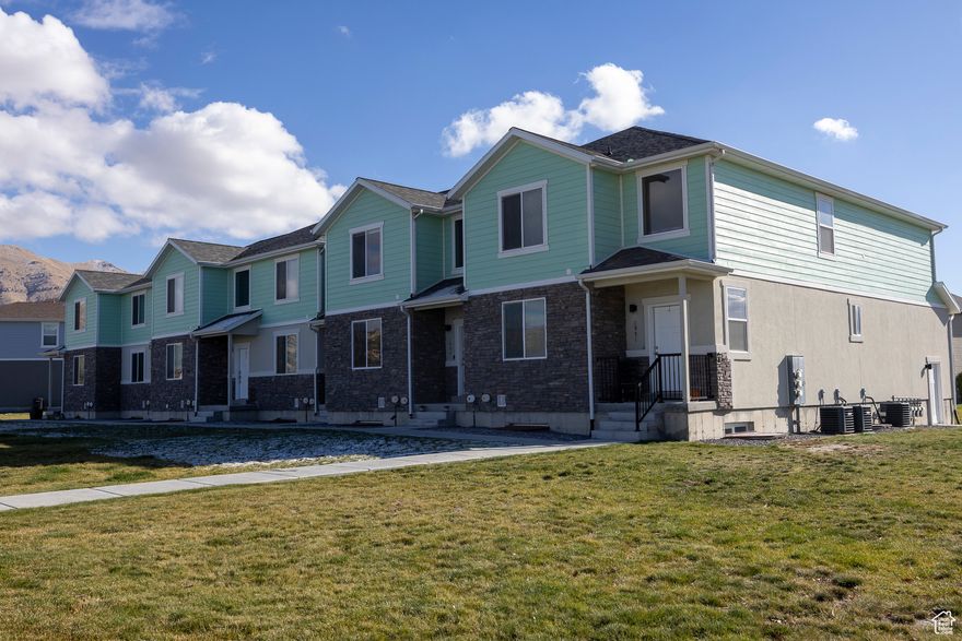 This stunning townhome in Eagle Mountain combines comfort, style, and convenience. Enjoy breathtaking mountain views with nearby parks, schools, shopping, dining, and endless outdoor activities just minutes away.  Inside, you'll find 9' ceilings and an open-concept layout that feels bright and spacious. The kitchen features granite countertops, a gas range, ample storage, and durable LVP flooring-perfect for both everyday living and entertaining.  The master suite offers a true retreat with upgraded lighting, a luxurious bathroom, and a generous walk-in closet. The unfinished basement provides endless possibilities-pre-plumbed for a kitchen and bath and equipped with upgraded electrical, making it ideal for a future entertainment space.  Additional highlights include a two-car garage with extra storage and a fridge that is negotiable. This home shows like a model and is truly a must-see!  Square footage figures are provided as a courtesy estimate only and were obtained from tax records. The buyer is advised to obtain an independent measurement.