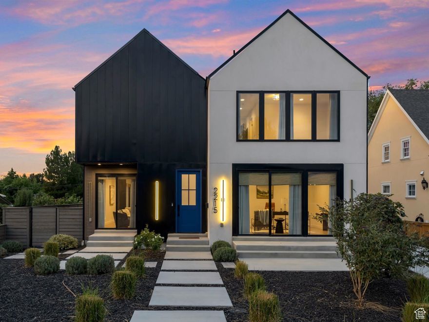 Don't miss this rare opportunity to own a sophisticated, newly built residence in the sought-after East Millcreek area! Built in 2022, this exceptional home seamlessly combines smart design, premium finishes, and a prime location. The eye-catching exterior features expansive windows, crisp white stucco, architectural metal roofing, and contemporary metal accents. A thoughtfully landscaped front yard leads to a welcoming entry patio and custom front door, setting the stage for the elegance within. Inside, the home offers an abundance of natural light and a warm, open ambiance highlighted by exposed beams, soaring ceilings, oversized doors, designer lighting, modern iron railings, and rich hardwood flooring. The versatile layout includes 6 bedrooms, 5 bathrooms, a formal living room or den, spacious great room, mudroom, open loft, home theater, recreation room, and an oversized 4-car garage. The kitchen is a culinary showpiece with a generous center island, top-of-the-line stainless steel appliances, gas range, double ovens, custom tile backsplash, floating shelves, waterfall-edge quartz countertops, statement pendant lights, and abundant custom cabinetry. A full-size refrigerator is included. The adjacent butler's pantry offers extra prep space and storage-perfect for entertaining. Dine casually at the island or in the inviting dining area. The adjacent great room is designed for gathering, centered around a gas fireplace with a dramatic tile surround, and enhanced by expansive windows and a built-in bar area. From here, step outside to enjoy a private patio and fully fenced backyard complete with an in-ground trampoline-ideal for relaxation or play. Upstairs, the airy loft provides flexible space for a home office, playroom, or lounge and opens to a private deck. The serene primary suite offers a spa-inspired retreat with built-in cabinetry, dual vanities, a deep soaking tub, and a spacious walk-in shower. The fully finished basement continues the home's versatility with high ceilings and multiple living zones, including a home theater, recreation area, plumbing for a future wet bar, two bedrooms, a large Jack-and-Jill bathroom with a steam shower, and cleverly hidden storage rooms tucked behind built-in bookcases. Constructed with premium upgrades, this home includes 2x6 framing, blown-in insulation in both walls and floors, two high-efficiency furnaces, a humidifier, dual A/C units, a tankless water heater, casement windows, recessed lighting, a smart thermostat, and ceiling fans throughout. The attached 4-car garage includes a convenient faucet for car washing, a MyQ smart door system, an EV charging outlet, and ample room for storing gear, bikes, or other equipment. All of this, located just minutes from downtown Salt Lake City, the University of Utah, top-rated schools, shopping, dining, parks, Millcreek Common and world-class ski resorts. Experience luxury, comfort, and location-all in one extraordinary home.
