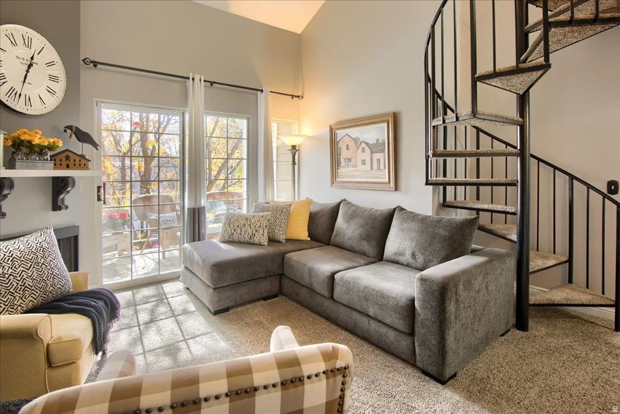 Welcome home to this bright and spacious top-floor condo in the desirable Carriage Crossing community. You'll love the open, airy feel of the two-story layout with tall, vaulted ceilings, large windows, and a cozy gas fireplace. The large upstairs loft adds incredible versatility - perfect for a home office, TV room, or even a third bedroom. Enjoy updated flooring and modern fixtures and hardware throughout. The kitchen has been tastefully refreshed, and the primary suite features an attached bathroom for added convenience. Step outside to a covered balcony with a storage closet for added functionality. This park-like community offers beautiful grounds and amenities including a clubhouse, pool, and tennis court. HOA dues cover water and sewer, and residents enjoy private gate access to Smith's Marketplace. The public library and police station are just across the street, with easy access to I-15, bus lines, and historic Main Street. Only 15 minutes to Salt Lake International Airport and downtown Salt Lake City. Immaculately cared for and move-in ready, this home can be sold furnished for the right offer. Experience low maintenance living in a peaceful, well-maintained setting!