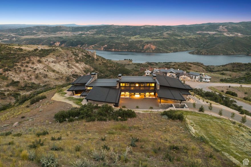 Experience next-level mountain luxury in this newly constructed 7 bed/11 bath 11,775 SQFT residence. Situated on over two acres in the Lone Peak neighborhood of Tuhaye, this magnificent home offers privacy, space, & breathtaking 270-degree sunset views spanning the Jordanelle, Deer Valley, Mount Timpanogos, Uinta Mountains & the unique Tuhaye Hoodo rock formations. Designed for grand entertaining & effortless indoor-outdoor living, the open-concept great room showcases floor-to-ceiling retractable glass that opens to a heated patio with built-in grill, fire pit, & hot tub. Chef's kitchen features top-of-the-line appliances, double islands, custom cabinetry, & an expansive butler's pantry-perfect for intimate meals or elegant dinner parties. Set on the main level is a 3 room Master suite which is a sanctuary onto itself, with an office, sitting area, double sided fireplace & endless views from inside or on the private patio. The Master bathroom features dual vanities, dual dressing areas, dual toilet rooms, a glorious shower & large soaking tub.  Also, on the main level are 3 additional ensuite bedrooms, one of which is a bunk room with sitting area & dual full baths, a laundry room with double washer & dryer & a private home gym with steam shower & sauna. Downstairs, the lower level provides entertainment for guests, with a junior master & 2 additional guest bedrooms, all of which are ensuite, large family room with gaming room, wet bar & game table. The residence is completed by additional front patio & an oversized four car garage that is equipped with two electric car chargers allowing for more than ample space for all types of vehicles. This rare combination comes furnished, with impeccable pieces handpicked by Suzanne McCammon of Oohs & Aahs Furniture & Design. A Full Talisker Club Membership is included, unlocking a suite of world-class amenities at your fingertips, including golf, dining, spa, & exclusive mountain ski access at Tower Club at Empire Pass.