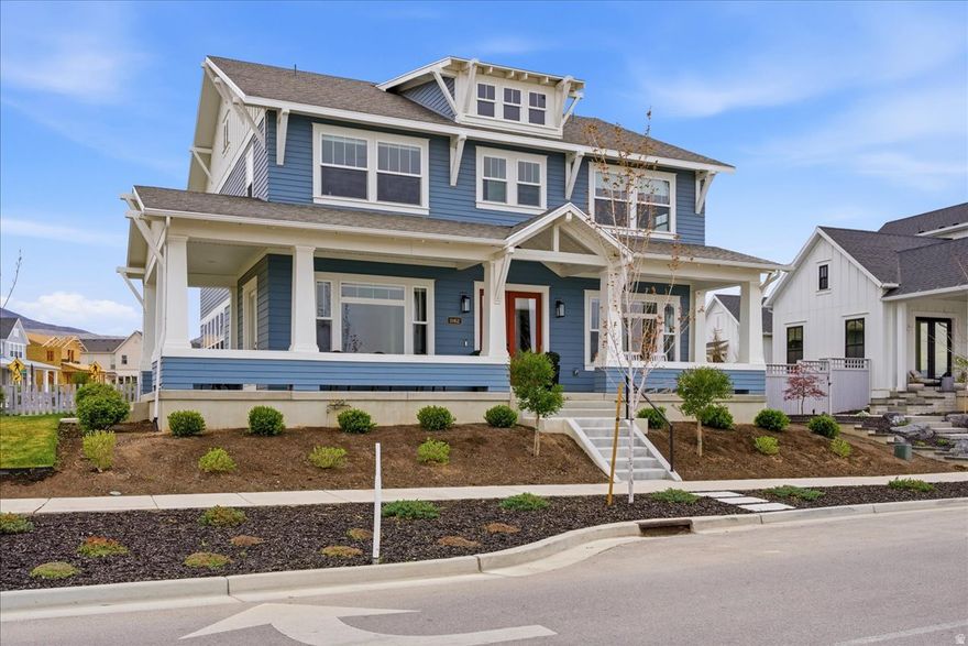 Used as a second residence and lived in for only a few months, this near-new home has been meticulously maintained and offers the benefit of completed construction without the timeline of building. Completed in 2024 and positioned on a premier corner lot-one of the largest along the watercourse-this home sits directly across from the waterways, in South Jordan's Daybreak community, with mountain views and a setting that feels open, quiet, and connected. Immediate access to walking paths and outdoor spaces enhances the lifestyle this location provides. Thoughtfully built by Rainey Homes, it stands apart through craftsmanship and intentional design. Wood-beamed and coffered ceilings, expansive windows, and custom built-ins create a sense of depth, warmth, and natural light throughout. Every space feels considered, elevated, and reflects a level of design rarely found in new construction. The main level is designed for both everyday living and entertaining, with a dedicated office, formal dining room, and a spacious family room anchored by a custom fireplace with a full wall of white oak built-ins. The layout flows seamlessly, defined by clean lines and layered textures. The kitchen is both refined and highly functional, featuring custom cabinetry, a statement hood with pot filler, paneled refrigerator and freezer, double dishwashers, pebble ice machine, oversized island, a generous walk-in pantry, and a dedicated coffee bar. Upstairs, the primary suite offers a true retreat with dual walk-in closets and a spacious, spa-inspired bath featuring extensive cabinetry and storage, a freestanding soaking tub, and an oversized walk-in shower. The fully finished basement expands the home's versatility with a large family room, dedicated gym, wet bar kitchenette, and additional living space well suited for guests or large families. Two laundry rooms-one on the upper level and one in the basement-add convenience and flexibility across the home. Additional features include a thoughtfully designed mudroom with built-in storage, custom window treatments throughout, a three-car garage with EV charging, and an expansive backyard with a large paver patio-set on one of the most usable lots along the watercourse. The home includes a dedicated gym, which is counted as a bedroom. A home defined by craftsmanship, thoughtful design, and a setting that is increasingly difficult to recreate.