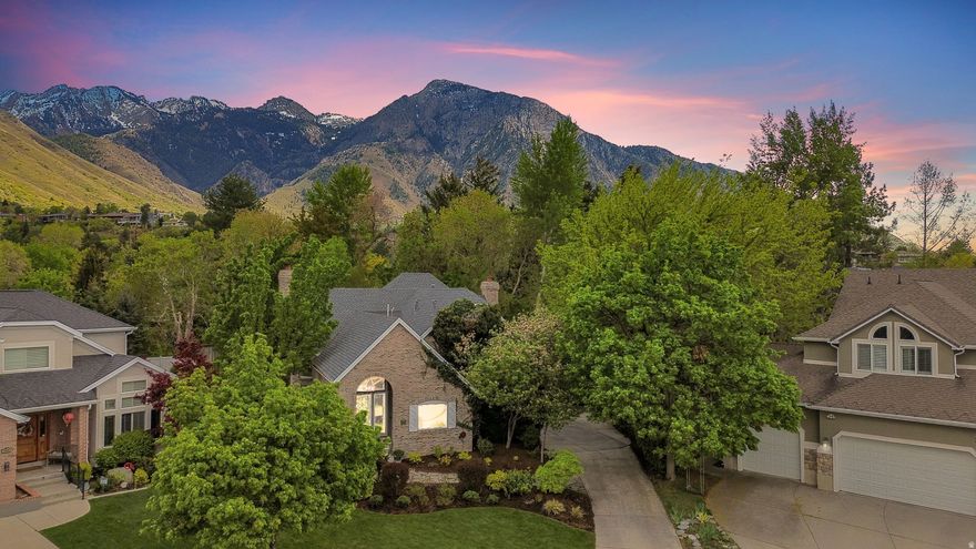 Architecturally designed and full of charm, this stunning custom home nestled on a quiet cul-de-sac near Millcreek Canyon offers a rare blend of privacy, serenity, and natural beauty. Thoughtfully updated throughout, this home features a beautifully remodeled kitchen, updated bathrooms, new windows, new roof, new water heater, new boiler, updated HVAC/AC, radiant flooring throughout, and new carpet-creating a truly turnkey and elevated living experience.  The private main suite is a peaceful retreat, complete with a standalone soaking tub and its own fireplace-perfect for relaxing and unwinding in comfort. Additional features include radiant floor heating, three fireplaces, a heated three-car garage, and abundant storage throughout.  Designed for both everyday living and entertaining, this home offers 4 spacious bedrooms, 3 full baths, and 2 half baths, along with a dedicated fitness room and private theatre room-bringing lifestyle and convenience together in one exceptional space.  Situated on an award-worthy lot, the lush landscaping is filled with vibrant perennials, while Millcreek flows year-round through the property-creating a truly magical, storybook backyard retreat ideal for relaxing, entertaining, and enjoying nature right at your doorstep.  Located in a highly desirable neighborhood with top-rated schools, easy freeway access, and just 20 minutes to downtown Salt Lake City and Park City, this home offers the perfect balance of convenience and escape.  Priced aggressively, this is a rare opportunity to own a private sanctuary where comfort, beauty, and lifestyle come together. Let your dreams come to life.