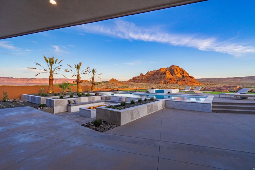 2026 Parade Home-Discover elevated desert living at The Advenire, a luxury residence perfectly positioned behind the fairways of Sand Hollow Golf Course. Designed for those who want both refinement and adventure, this home blends sophisticated style with the natural beauty of Southern Utah. Floor-to-ceiling windows flood the interior with light and showcase stunning golf course and red rock views. The open-concept layout flows effortlessly between the gourmet kitchen--featuring Monogram appliances, a wine fridge, and ice maker--and expansive living spaces ideal for entertaining or relaxing. Step outside to inviting patios and terraces for sunrise mornings and sunset evenings. Enjoy smart home automation, a spacious toy/boat garage, and instant hot water heaters.