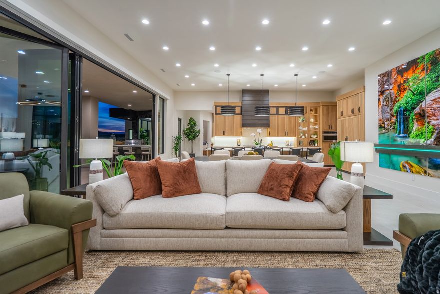 2026 Parade Home-Discover elevated desert living at The Advenire, a luxury residence perfectly positioned behind the fairways of Sand Hollow Golf Course. Designed for those who want both refinement and adventure, this home blends sophisticated style with the natural beauty of Southern Utah. Floor-to-ceiling windows flood the interior with light and showcase stunning golf course and red rock views. The open-concept layout flows effortlessly between the gourmet kitchen--featuring Monogram appliances, a wine fridge, and ice maker--and expansive living spaces ideal for entertaining or relaxing. Step outside to inviting patios and terraces for sunrise mornings and sunset evenings. Enjoy smart home automation, a spacious toy/boat garage, and instant hot water heaters.