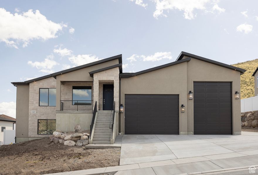 This brand-new custom home is a rare find-crafted with care by a respected local builder known for quality construction and attention to detail. Home is built with a great room open-concept that is bright and welcoming, with large windows framing the natural landscape. A chef-inspired kitchen features custom cabinetry, high-end appliances, and a spacious island ideal for gathering. The master suite offers a peaceful retreat with a spa-like bath and walk-in closet with laundry room access while the other bedrooms provide flexibility for family or guests. One of the home's standout features is the oversized RV garage-perfect for storage, travel, or hobby space. Downstairs, the fully finished basement includes a private accessory dwelling unit (ADU) with its own entrance, kitchen, and laundry-ideal for guests, rental income, or multigenerational living.  Built with lasting quality and designed for real-life living, this home offers everything you need-and more-in a location where natural beauty surrounds you every day.