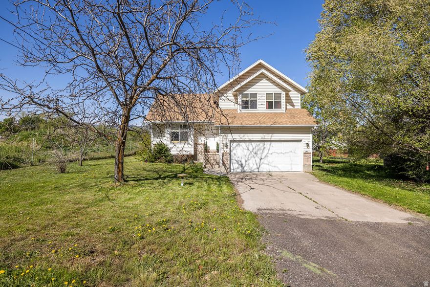 Come see this affordable 5 bed home on .31-acre lot. This home is built for a full life with a layout designed for both privacy and connection. Enjoy a yard that feels like a private park with mature trees and ample room for RV/toy parking. You're minutes from Hyrum Reservoir, Hyrum Skate Park, and the Blacksmith Fork River Trail. Perfect for those who love space and the outdoors!