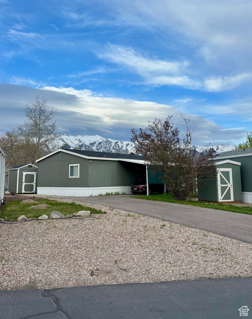 **contingent buyer backed out - BACK ON MARKET** Great location and great price! This double wide feels spacious with 3 bedrooms, 2 full bathrooms and a large open living/kitchen area. The home comes with 2 sheds, a covered back deck and a fully fenced yard - one of the largest in the community, great for kids and/or pets. Extra long driveway that can accommodate multiple cars if needed on the secondary driveway as well. Located right by HAFB, restaurants, shopping, schools. Quick access to Highway 89 or I-15. This community has a pool, basketball court, playground, clubhouse and bbq area. There is a lot of space to take walks with family or pets. Safe and friendly neighborhood.  Square footage figures are provided as a courtesy estimate only and were obtained from Rolling Hills records.  Buyer is advised to obtain an independent measurement.