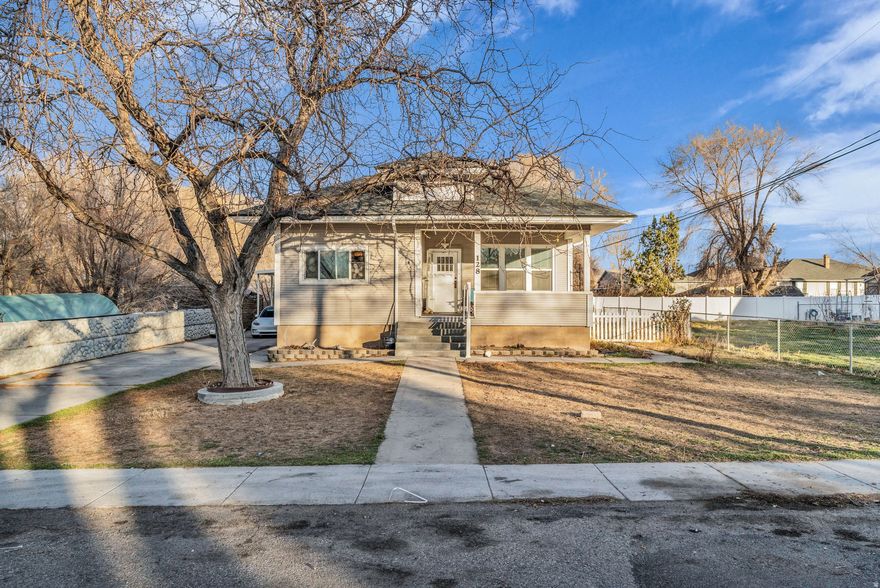 Built in 1915 and thoughtfully updated in 2013, this classic farmhouse offers a rare blend of early character and mid-century charm, ready for its next chapter. Situated on a spacious .36-acre lot, the property features a large, separately sectioned gardening area just south of the home, complete with irrigation hook ups and rich, fertile soil-previously used as a productive garden. Irrigation shares must be rented separately.  A backyard chicken coop adds to the property's farmhouse appeal.  The home offers abundant parking, a covered RV parking area, and an existing RV electrical hookup located on the south side near the garden lot. A workshop tucked beneath the back porch provides excellent space for projects, storage, or hobbies. Built-in holiday lighting adds a fun and functional touch.  This property is being sold as a short sale and will require care and updates as well as price and terms approval by the bank. This is an excellent opportunity for a buyer with vision to restore and customize a property with strong bones, usable land, and unique features rarely found at this price point.