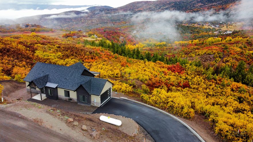 Mountain living with unobstructed canyon views are waiting in this new custom home. This prime location features an array of outdoor activities, including paddle boarding, hiking, biking, and ATV trails or snowmobile to thousands of acres of forest from your own garage. Impress your guests with your culinary skills using the double oven and elegant cabinetry, while enjoying the local deer and moose from your deck. The walkout basement that invites you to intimately explore nature. With large windows and a spacious deck, this exquisite home seamlessly integrates the beauty of the outdoors with luxurious interiors. With a large second primary bedroom in the basement you'll have room for everyone. Whether cozying up by the fire in winter or entertaining on the deck in summer, you will relish the harmony of luxury living. You'll engage in nature, all while enjoying the comforts and conveniences of your brand new custom home in this idyllic gated community. See it today!