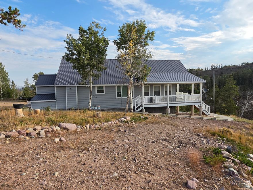 Charming Cabin Retreat in Manor Lands  5 Acres with Stunning Views  Escape to your own private mountain getaway in the gated Manor Lands community. This cozy yet roomy cabin sits on 5 pristine acres with sweeping views and a peaceful creek running below. The interior offers a warm and welcoming atmosphere. It feels like a return to the old days when life was quiet and grandma would wrap you up in a blanket and keep you fed and protected from the world.   The highlight of this property is the expansive deck, perched above the creek, where you can relax, entertain, and soak in the fresh mountain air. An oversized two-car garage provides plenty of storage for vehicles, ATVs, or outdoor gear, while the firepit area is ideal for evenings under the stars.  Enjoy the serenity of nature, unmatched privacy, and the beauty of Manor Lands-a true escape from the everyday.