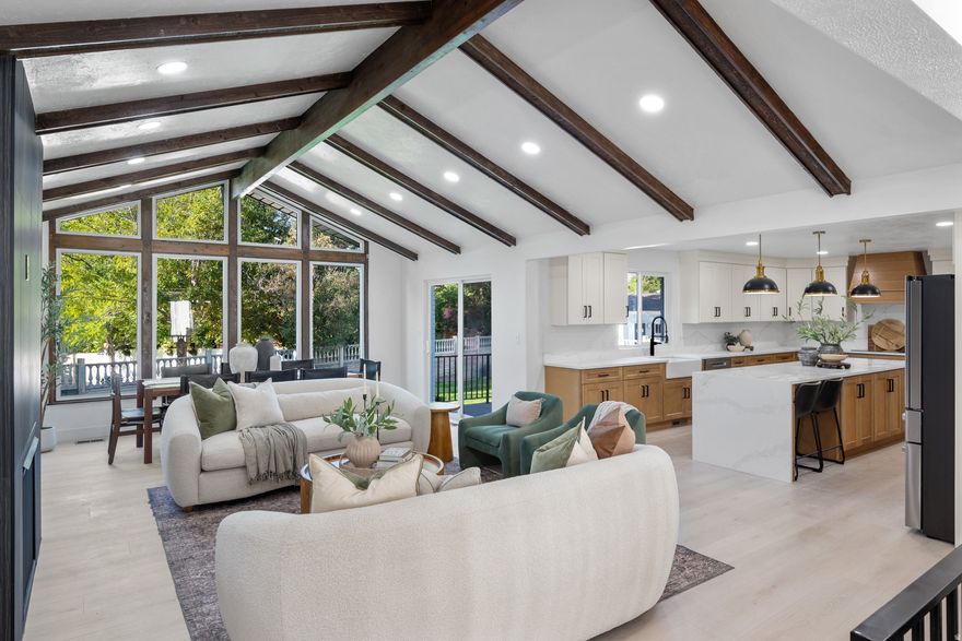 Seller offering 1/0 rate buydown with preferred lender - 5.261% first-year rate available PLUS an additional 1% concession!  Contact agent for details. This stunning, fully renovated home is located just minutes from the prestigious Willow Creek Country Club, nestled in one of the most desirable pockets of the Salt Lake Valley. With breathtaking mountain views, a spacious layout, and designer finishes throughout, this property is a rare find. Boasting over 4,000 square feet, the home features six bedrooms, including a fully finished basement with a separate kitchenette, perfect for entertaining, extended guests, or multigenerational living. The heart of the home is an expansive great room with soaring ceilings and exposed beams, creating a dramatic and inviting space for gatherings. The kitchen is one of the largest you'll find, completely reimagined with luxury in mind and equipped for everything from quiet mornings to hosting a crowd. A spacious butler's pantry offers added storage and prep space, ideal for those who love to cook or entertain. Step outside to enjoy a lush green yard with room to relax, play, or garden, all surrounded by mountain beauty. Opportunities like this in the Willow Creek corridor are rare. Schedule your private showing today.