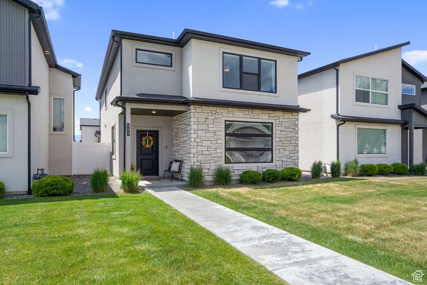Welcome to this impeccably maintained 2-story home that offers the perfect blend of modern comfort, functional design, and low-maintenance living in a peaceful setting facing a large grassy common area with no busy roads nearby. Inside, you'll find an open-concept layout filled with natural light from oversized windows and thoughtfully designed gathering spaces perfect for everyday living and entertaining. The kitchen features a large island upgrade with additional storage underneath, quartz countertops, stainless steel appliances, and plenty of room to gather. The spacious loft upstairs includes custom-built-in cabinetry, creating the perfect flex space for a second living room, office, or play area. The home's layout was designed with comfort in mind, with large bedrooms, abundant storage throughout, and an incredible primary suite complete with a spacious walk-in closet and an oversized shower. Additional upgrades include a tankless water heater, bump-out garage for extra storage or workspace, and a fully fenced backyard that is maintained by the HOA for truly easy living. Located just minutes from Utah Lake, shopping, restaurants, freeway access, and major commuter routes, this home also gives you access to incredible community amenities including: a pool, playgrounds, pickleball court, clubhouse, and lots of open green spaces. If you've been looking for a move-in-ready home that still feels brand-new with modern finishes, functional spaces, and an unbeatable community feel, this is one you won't want to miss.  Square footage figures are provided as a courtesy estimate only and were obtained from County Records.  Buyer is advised to obtain an independent measurement. Some maps struggle to navigate to the correct address. Feel free to contact the agent for a pin.