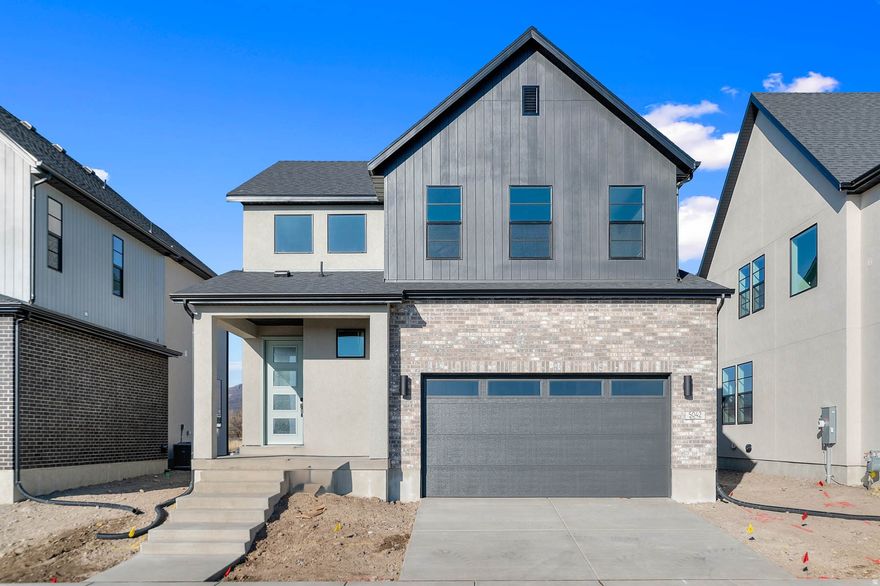 Introducing the Nyborg, a beautifully upgraded home showcasing modern style and thoughtful craftsmanship. The kitchen features gray laminate cabinetry, sleek quartz countertops, a tile backsplash, and stainless steel gas appliances-a perfect blend of function and design. Durable laminate hardwood flooring pairs seamlessly with tile and carpet throughout the home. Can lighting, 2 tone paint, and Christmas light outlets add convenience and comfort, while energy-efficient options and a tankless water heater ensure long-term savings. A striking metal railing at the stairway and detailed Craftsman base and casing elevate the home's interior. The owner's bathroom offers a spa-like feel with cultured marble shower surrounds and stylish black matte hardware. This home is the ideal combination of modern finishes, efficiency, and timeless appeal!