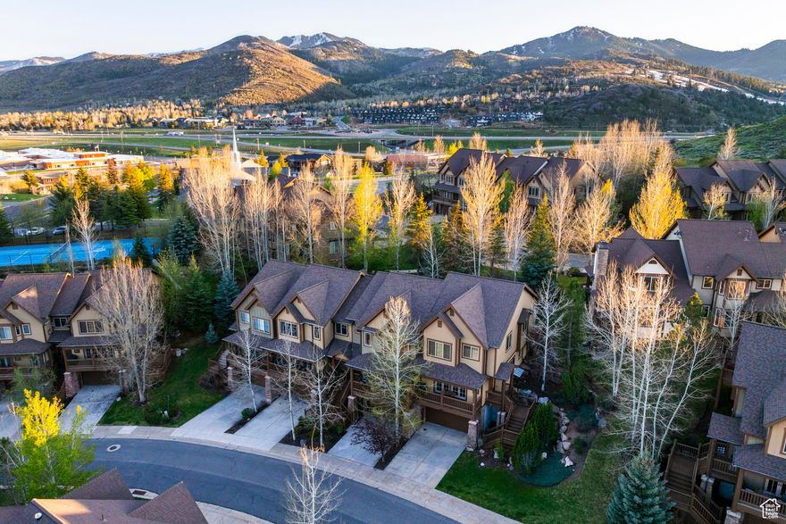 Discover the ultimate mountain lifestyle in this beautifully appointed townhome, perfectly located in the sought-after Canyon Links community of Jeremy Ranch. Just minutes from Park City's world-renowned ski resorts, golf courses, and endless hiking and biking trails, this home offers year-round adventure right at your doorstep, with Downtown Salt Lake City and Utah's new international airport only a short drive away. Inside, an open floor plan with soaring ceilings on every level creates a bright, inviting atmosphere. The main level features a spacious living room with a cozy gas fireplace, bar seating, and an informal dining area that opens to a large deck-ideal for aprs-ski evenings or relaxing with mountain views. A generous guest suite and powder bath complete this level. Upstairs, the luxurious primary suite is joined by two large bedrooms and a shared bath, with a convenient laundry room nearby and access to peaceful green space. Ample storage and thoughtful details add comfort throughout. The lower level includes a mudroom entry and an oversized two-car garage with two large storage rooms for all your outdoor gear. Enjoy stunning mountain vistas and the perfect blend of adventure and convenience in this ideal Park City retreat.