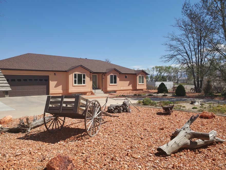 ONE-OF-A-KIND SOUTHERN UTAH DREAM PROPERTY   Luxury  Privacy  Space  Comfort  Adventure Welcome to this exceptionally maintained 4,700 sq. ft. custom rambler nestled on 1.05 fully landscaped acres within Milford City limits.   Built in 1997 with timeless craftsmanship and meticulous care, this stunning 5-bedroom, 3-bath estate offers the perfect blend of luxury living, peaceful privacy, and unmatched functionality. Set back from the street for a quiet, secluded feel, this home immediately impresses with its expansive layout, mature landscaping, and elegant curb appeal. Inside, you'll find warm custom oak cabinetry throughout, spacious living areas, tasteful neutral finishes, and premium built-in storage designed for both beauty and convenience.   The oversized chef's kitchen features abundant custom cabinetry, expansive counter space, a large center island with built-in seating, and an adjoining dining/sitting area perfect for entertaining family and guests.   At the heart of the home is a beautiful wood-burning stove with tiled hearth, creating a warm and inviting atmosphere while also serving as an efficient supplemental heat source during winter months. The stove is capable of heating the entire main level if the power goes out for an extended period of time.   The spacious primary suite offers a relaxing retreat complete with a large jetted tub, while all upstairs bedrooms feature professionally installed closet organizing systems. A custom executive office/den showcases stunning oak built-ins, bookshelves, and a built-in desk ideal for working from home.   The fully finished basement expands the home's versatility with:  2 additional bedrooms  Large family room  Game room    Dedicated exercise room    Walk-out basement access  Massive food storage room with built-in shelving and chest freezer  Additional storage room with sink and kitchenette potential     Car enthusiasts, hobbyists, and outdoor adventurers will appreciate:  Attached 1,000 sq. ft. finished garage with built-in shelving  Detached 900 sq. ft. stucco workshop/garage with benches, shelving, and dual roll-up doors  Large circular driveway  Extended 200 ft. gravel driveway with extensive RV & equipment parking   The outdoor amenities are truly incredible:  Fully landscaped 1.03-acre lot  Mature trees and established shrubs  Approximately 3,600 sq. ft. of garden space    Automatic sprinkler system  Decorative rock landscaping  Large playground with Cedar Works play set    Fire pit & picnic area    Horseshoe pits  Fountain/bird bath    Fully stocked woodshed     Major upgrades include:   New roofs on home and detached garage (2021)   New front windows (2022)   Fiber optic internet availability   Central air & forced air gas heat   Outdoor recreation is right at your doorstep. Ride your ATV directly from the property and access hundreds of miles of scenic Southern Utah trails, mountain roads, historic mining camps, ghost towns, and beautiful desert landscapes. This extraordinary property offers the rare opportunity to own a luxury home with space to entertain, garden, explore, work, and create lifelong memories - all in one remarkable setting.   Seller is including the chest freezer in the food storage room and the weight machine in the exercise room. Square footage figures are provided as a courtesy estimate only.  Buyer is advised to obtain an independent measurement.