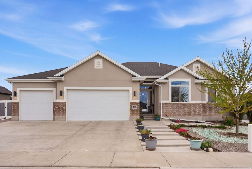 Beautifully maintained rambler on a spacious corner lot in Stansbury Park. Sitting on a quarter acre, this home offers a rare combination of space, function, and easy outdoor living.  The main level features 3 bedrooms and 2 bathrooms with a bright, open feel and clear pride of ownership throughout. The kitchen is finished with leathered Brazilian stone countertops, adding a unique, high-end touch. Permanent trim lighting adds both curb appeal and year-round convenience.  Downstairs, you'll find a fully finished basement with a large second living space, an additional bedroom and full bathroom, plus plenty of storage.  The 3-car garage & RV parking provides ample room for vehicles, toys, and extra storage.  Outside is dialed in for low-maintenance living with fully xeriscaped front and back yards. Enjoy a greenhouse, multiple sheds, planter boxes, a fire pit, and a covered patio-perfect for relaxing or entertaining.  This home is move-in ready with thoughtful upgrades and space to spread out, inside and out.