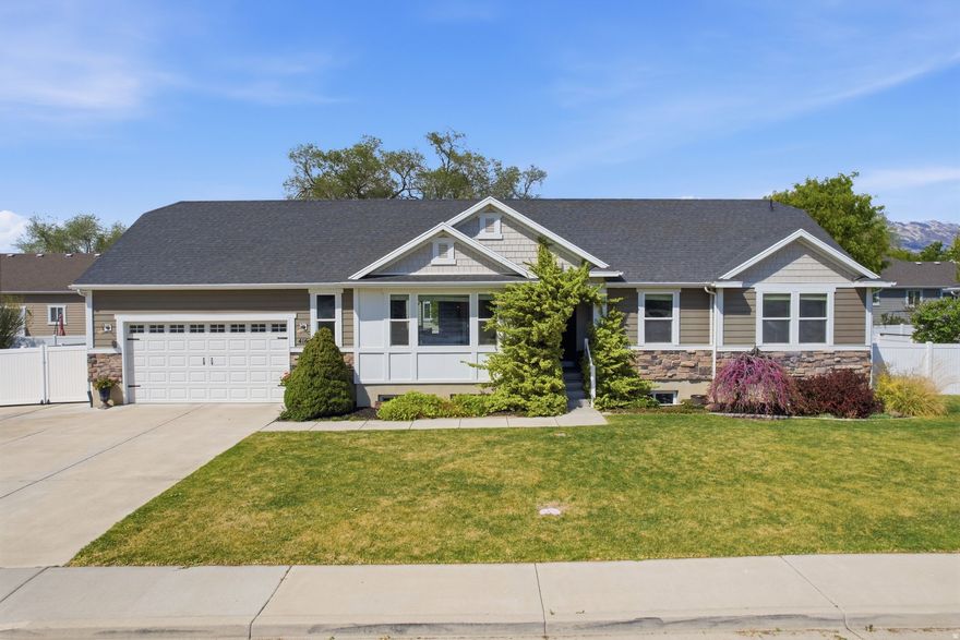 Come check out East Lehi's newest listing! This home features 5 bedrooms, 3 full bathrooms, main-level living, and a large fully finished basement with a separate entrance. A portion of the basement has been functioning as a salon but could easily be converted to a kitchenette for a potential ADU.  Not only does the home have it all, but the location is IDEAL! This south-facing home is quietly tucked just off the East 2100 N Lehi exit, close to parks, schools, dining, and shopping. Enjoy mountain views, a mature yard with garden boxes and flowering trees, and an extended backyard patio perfect for entertaining.  Additional highlights include no HOA, vaulted ceilings in the family room and kitchen, a large and bright basement recreation space and a wide driveway with extra parking.   Come tour this home for yourself at our open house - Saturday, April 18th, 2026 11 am to 2 pm. No showings prior to the open house.  Square footage figures are provided as a courtesy estimate only and were obtained from the builders plans.  Buyer is advised to obtain an independent measurement.