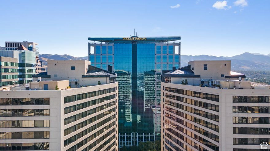 Stunning downtown living! Completely renovated 1-bed, 1.5-bath condo on the 17th floor of American Towers. Chic kitchen with Quartzite countertops and backsplash, custom cabinetry, upgraded stainless steel appliances, and stainless faucet and hardware. The primary bath features a porcelain tile shower with Quartzite bench, Quartzite countertops, and dual vanities. Additional highlights include LED lighting throughout, LVP flooring, custom crown molding, custom living room cabinetry, and motorized Hunter Douglas shades. Amenities include an indoor swimming pool, sauna, gym, racquetball courts, 24/7 security, and assigned parking. The rooftop offers sweeping 360 views, relaxing hot tubs, and a BBQ area. Prime location with easy access to events, restaurants, shopping, I-15, the airport, and the University of Utah. The epitome of classy urban living. Square footage figures are provided as a courtesy estimate only and were obtained from county record. Buyer is advised to obtain an independent measurement.