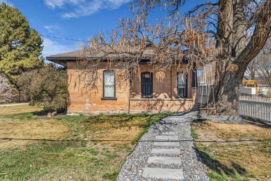 Timeless charm and modern updates in this cozy turn of the century brick home, nestled in the sought-after east of freeway accessible neighborhood. There is so much character packed into this lovely home. Exposed stone on the inside of the living room add to the vibrance and originality. Fully renovated master bathroom with free standing tub and large shower. New bamboo flooring throughout, New Appliances and kitchen cabinets, quartz countertops and marble backsplash, Extra large master bedroom, Large closets. Outdoor fire pit area. This home is  perfect for those looking for a piece of history with all the  modern conveniences. Freestanding fireplace and washer and dryer are negotiable. Open House March 21st 2026 11am-1pm NO SHOWINGS until OPEN HOUSE