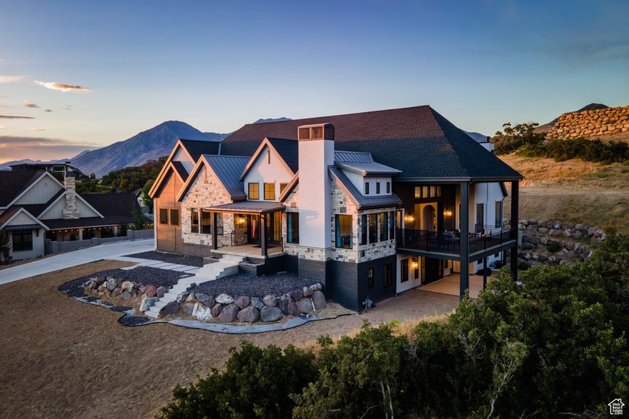 Completed in 2023, this expansive 9,010 sq ft masterpiece in the Twin Hollow Neighborhood of Mapleton offers an exceptional living experience with 6 spacious bedrooms, 6 bathrooms, and ample space for both family and guests. The open-concept design is perfect for entertaining. It boasts 3 large gathering areas, a den, and multi-slide doors that disappear into the wall and seamlessly connect the indoor and outdoor spaces. The huge deck offers breathtaking mountain views, while the daylight walkout basement is a standout feature providing easy access to the outdoor space. The heart of the home is the chef's kitchen which consists of two islands, a butler's pantry, and top-of-the-line Italian Bertazzoni appliances, including double ovens and a 6-burner stovetop with a grill. The master suite is designed to pamper, with vaulted ceilings and a large bathroom and closet. The lower level has a fantastic theater room with f 192" diagonal screen for the ultimate cinematic experience. Adjacent to the theater is a wet bar, craft room, and a large great room ideal for entertaining. Stay active and fit in a fun exercise room with glass walls, and enjoy the convenience of 2 laundry rooms within the home. The home is also equipped with three furnaces and AC units, and argon-filled aluminum windows and doors by Doorwin. The oversized garage can accommodate up to 5 vehicles, and as an added bonus, there is a hair salon with an exterior entrance that could be converted into a guest apartment. This is truly an extraordinary property- don't miss your chance to make it yours!