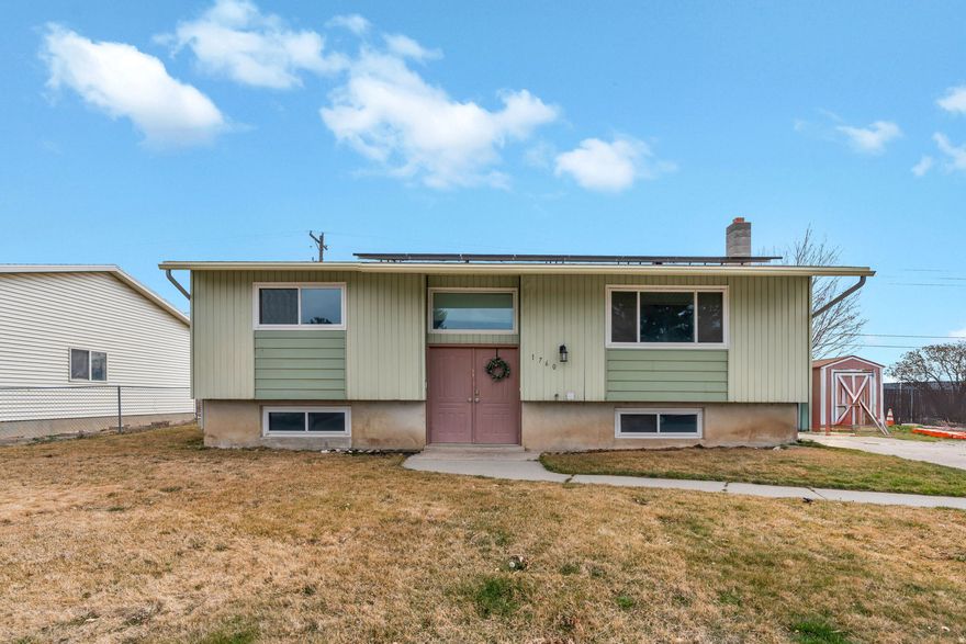 Welcome to this charming Split-Entry home in the heart of Lehi's Valley Vista subdivision. Listed at $535,000, this 2,000 sq. ft. residence offers a functional layout with 3 bedrooms and 2 bathrooms. Built in 1977, the home sits on a 0.184-acre lot and features a fully finished basement, providing ample living space for any lifestyle. The interior is highlighted by a spacious great room and comfortable living areas finished with a mix of carpet and linoleum flooring. Practicality meets comfort with double pane windows, a newer asphalt shingle roof, and efficient forced air heating paired with central air. For added safety and convenience, the home includes handrails on both sides of the stairs, and all curtains are included with the property. Outdoor enthusiasts will appreciate the fully fenced yard, mature landscaping, and a secluded backyard perfect for relaxing. The property also features a large shed for extra storage and uncovered parking. Energy-conscious buyers will love the owned solar panels, which contribute to lower utility costs. Located in the Alpine School District, this home is close to Eaglecrest Elementary and Skyridge High Square footage figures are provided as courtesy estimates only and were obtained from county records. Buyer is advised to obtain an independent measurement.