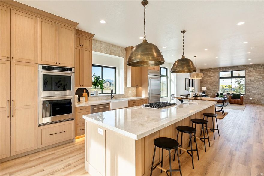 20K LENDER INCENTIVE!  Welcome to this stunning luxury townhome that masterfully blends elegance and functionality all in one! Featuring an open-concept floor plan, this home boasts a spacious kitchen outfitted with custom cabinetry, a large center island with Quartzite countertops, designer pendant lighting, and high-end stainless steel appliances including a gas cooktop and double wall ovens. The rich wood tones and soft neutral finishes create a warm, timeless aesthetic. Enjoy indoor-outdoor perfect for entertaining. The main living area is adorned with wide-plank luxury flooring, custom lighting, and recessed ceiling fixtures to highlight the home's modern charm.  **Photos may be of a similar unit used for reference only**